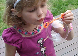 a girl blowing bubbles